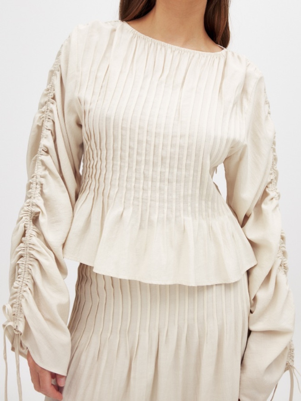 Pleated Cream Top with Ruched Sleeve Detail